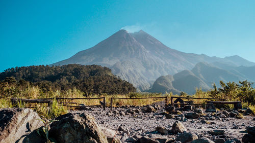 Scenic view of landscape and mountains against clear sky