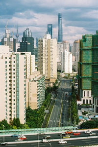 View of city street and buildings against sky