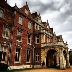 Low angle view of building against cloudy sky