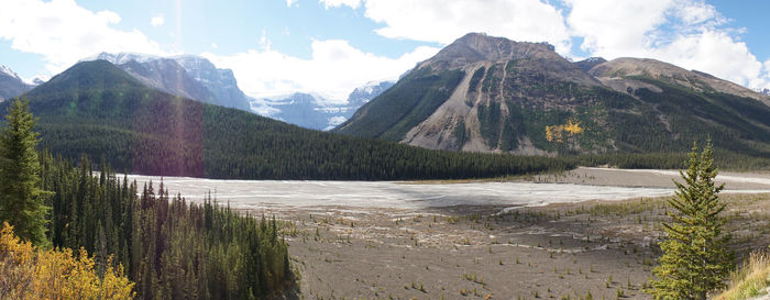 Scenic view of landscape and mountains against sky