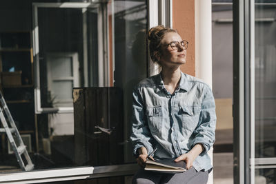 Young woman looking at book