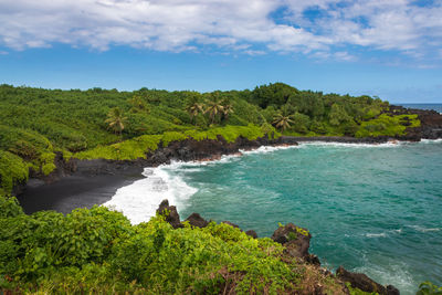 Scenic view of waianapanapa black sand beach, maui, hawaii along road to hana, usa against sky