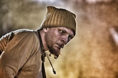 Close-up of man with knit hat looking away