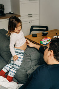 Women sitting on sofa at home