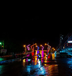 Illuminated city street at night