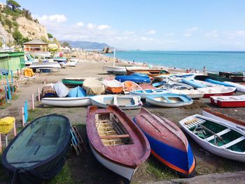 Boats moored on sea against sky