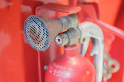 Close-up of red telephone on shelf at home