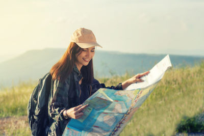 Young woman wearing hat standing outdoors