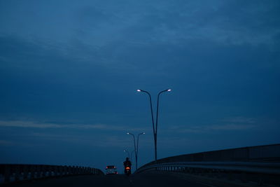 Street light on road against sky at dusk