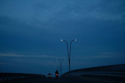 Street light on road against sky at dusk