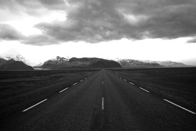 Empty road along countryside landscape