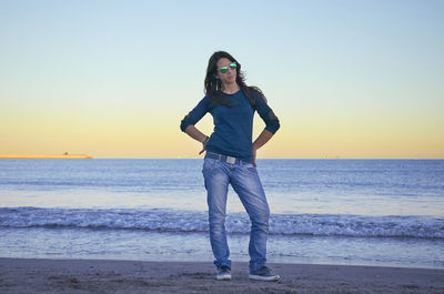 Full length of man standing on beach against sky