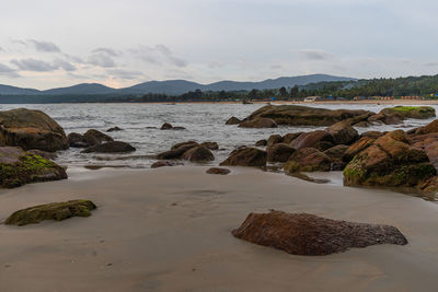 Rocks on beach against sky