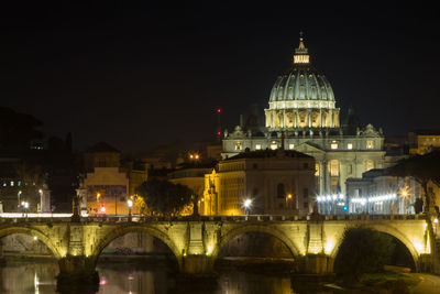 Illuminated arch bridge against sky at night