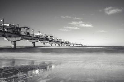 Bridge over sea against sky