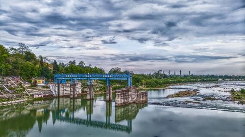 Scenic view of lake by building against sky