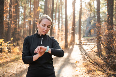 Portrait of young man exercising in forest