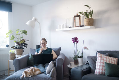 Woman in living room using laptop