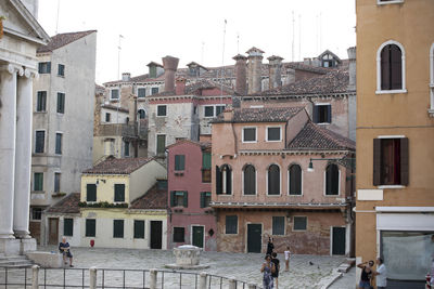 Residential buildings in city against clear sky