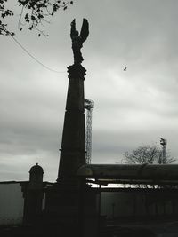 Low angle view of building against cloudy sky