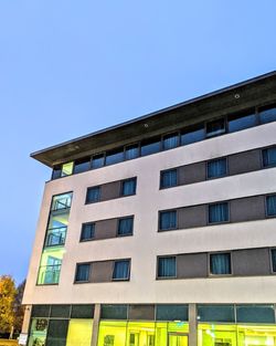 Low angle view of building against clear blue sky