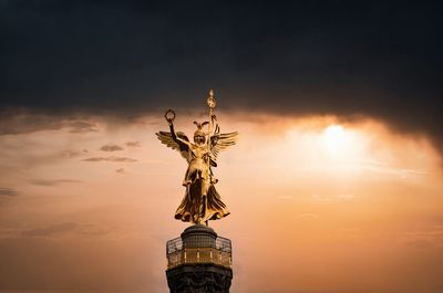 Low angle view of statue against sky during sunset