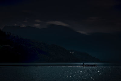 Scenic view of sea and mountains against sky