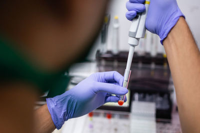 Midsection of doctor examining patient in laboratory