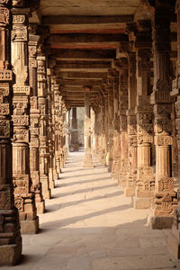 Columns with stone carving in courtyard of quwwat-ul-islam mosque, qutub minar complex, delhi, india