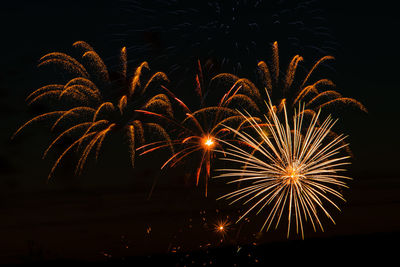 Low angle view of firework display at night