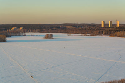 Scenic view of frozen lake during sunset