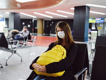 Woman sitting on seat in bus