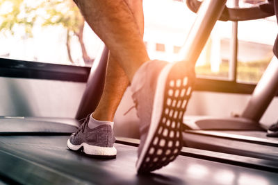 Low section of man running on treadmill