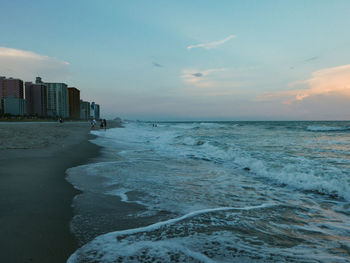 Scenic view of sea and buildings against sky