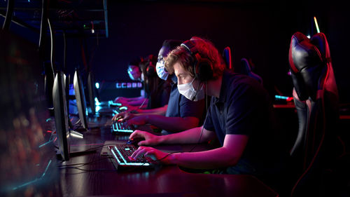 People playing video game in darkroom