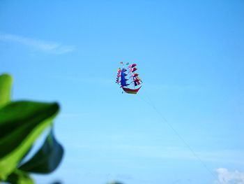 Low angle view of kite against blue sky