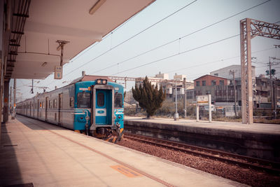 Train at railroad station against sky