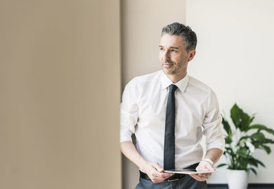 Portrait of businessman with tablet