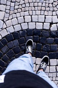 Low section of man standing on footpath