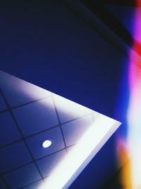 Low angle view of illuminated building against blue sky