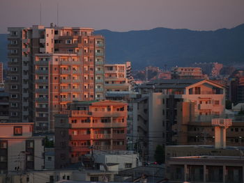 View of buildings in city at sunset