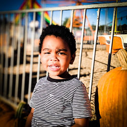 Portrait of smiling boy standing at home