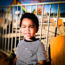 Portrait of boy standing at playground