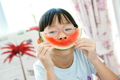 Close-up portrait of a boy eating fruit