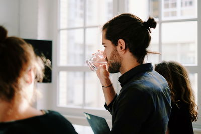 Side view of three people in office meeting