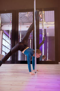 Low section of woman exercising in gym