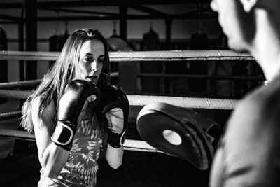 Woman on boxing training with personal trainer