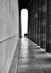 Rear view of people walking in building