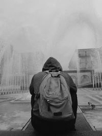 Rear view of woman standing against sky during winter