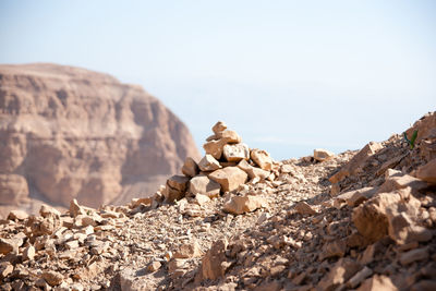 Surface level of rocks on land against sky